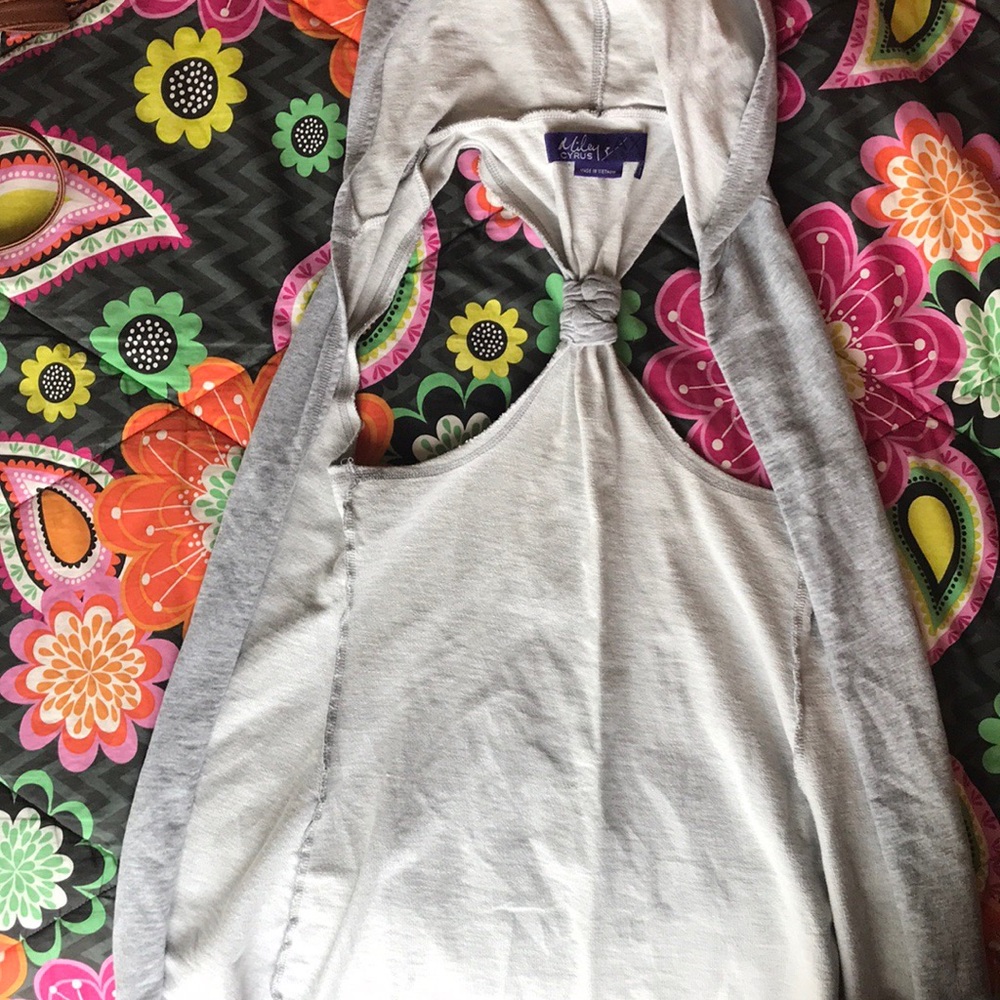 Miley Cyrus gray, sleeveless cardigan.